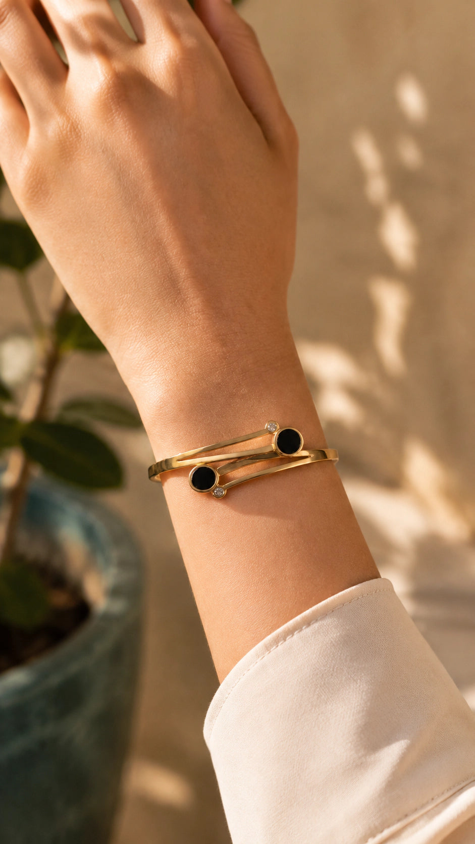 Gold and black artisan bracelet on wrist